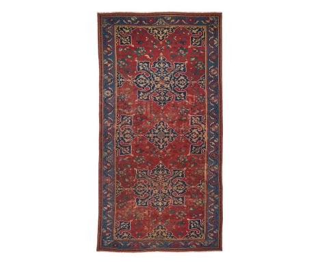 AN USHAK 'STAR' CARPET LATE 16TH/EARLY 17TH CENTURY Approximately 350 x 184cm  With a design of repeating star-shaped medalli