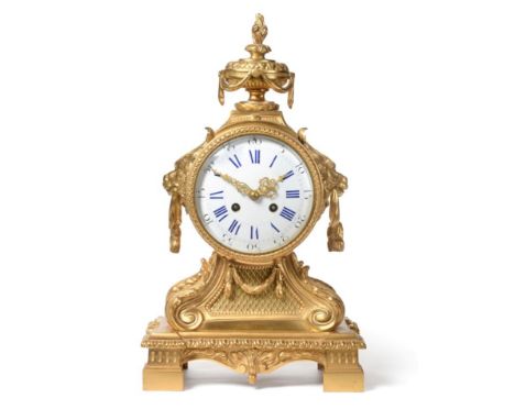 An Ormolu Striking Mantel Clock, circa 1890, urn finial and lion mask side carrying handles, 5-1/2-inch enamel dial with blue