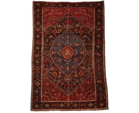 Good Saroukh Rug West Iran, circa 1920 The deep indigo field of angular vines around a sky blue medallion framed by floral sp