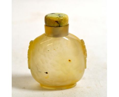 A Chinese Agate Snuff Bottle, 19th century, of flattened ovoid form with mask and ring handles, 2.5cm high
