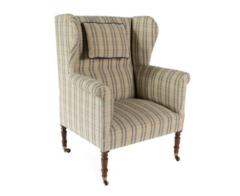 ^ A 19th Century Wing-Back Armchair, recovered in cream and blue striped fabric, with rounded arms and overstuffed seat, rais