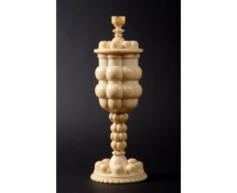 A Turned Ivory Pedestal Cup and Cover, South Germany, 2nd half 17th century, of lobed ovoid form on a similar stem, the cover