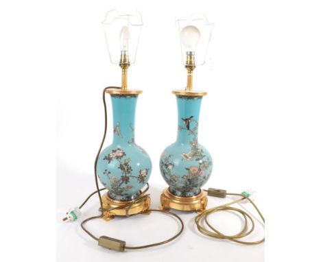 ~ A Pair of Japanese Cloisonné Enamel Bottle Vases, Meiji period, decorated with birds amongst flowering branches on a pale b