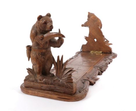 ~ A Black Forest Carved Wood Book Trough, late 19th century, with bear bookends, 53cm wide