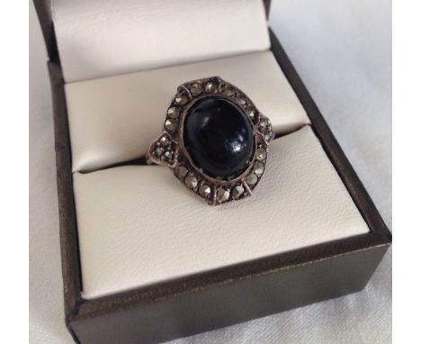 Silver marcasite dress ring with central oval onyx cabouchon. Size M.