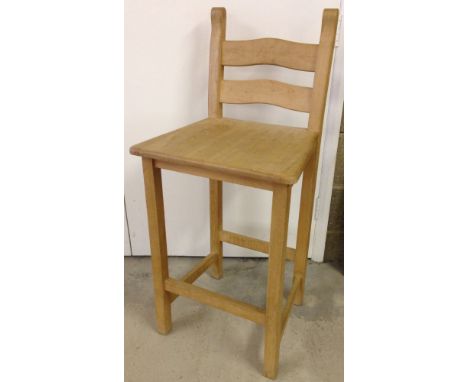A heavy light wood breakfast bar stool.