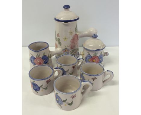 A French ceramic chocolate set comprising chocolate pot, milk jug, sugar bowl and 4 cups.