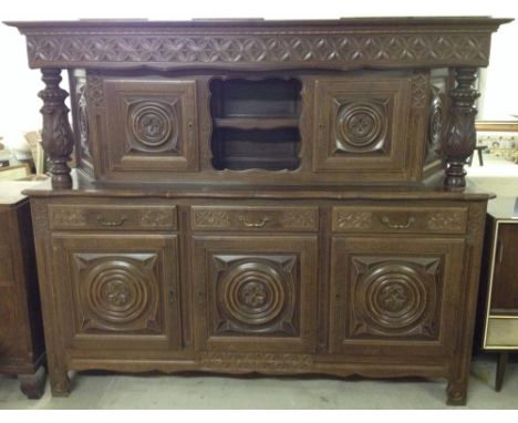 A solid oak traditional Breton buffet intricately carved with wheel design. 209cm, 6'10".