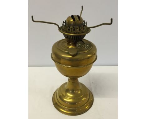 A brass oil lamp (no chimney).