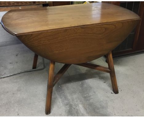 An Ercol oval drop leaf table.