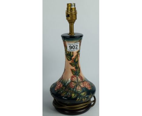 Moorcroft lamp base on wood plinth decorated in the Oberon design, height 33cm