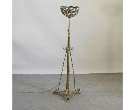 An early 20th century brass telescopic standard lamp, with a Tiffany style shade, 140cm