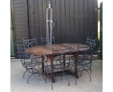 A teak extending garden table, 170 x 120cm, together with a set of six metal garden chairs and a garden spire