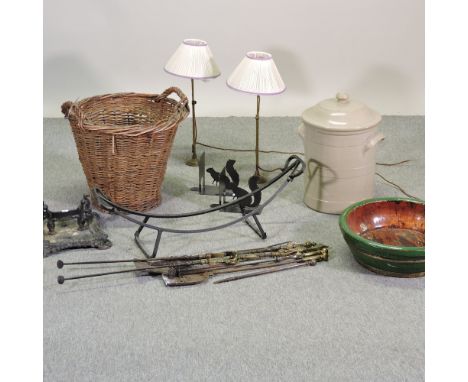 A wicker log basket, 50cm, together with a pair of Edwardian brass table lamps, fire tools and a cast iron boot scraper