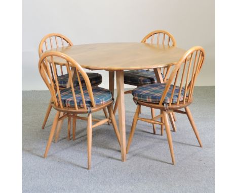 An Ercol light elm drop leaf table, 122 x 112cm overall, together with four Ercol light elm spindle chair dining chairs