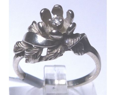 10 K DIAMOND FLOWER RING. 10 K white gold American diamond set flower ring, size L