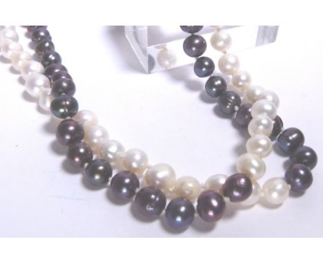 BLACK AND WHITE PEARLS. Black and white double row of pearls with clasp stamped 14 K L: 16 in