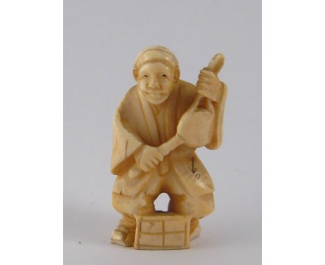 A Japanese ivory netsuke of a musician with drum. ht.5cm. Circa 1910.