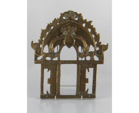 An Indian cast brass shrine surround, the rectangular opening with hooded cobra head surmount 23x26cm. 