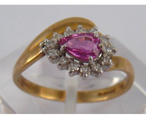 A 9 carat gold ruby and diamond ring, ruby approx 6 x 4mm, ring size N ½, 2 gms.