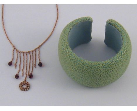 A mixed lot comprising a shagreen bangle, approx 42mm wide, together with a gilt metal (tests silver) garnet fringe necklace.