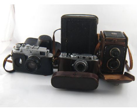 Four cameras, being a Rolleicord in ER case, a Soviet 35mm. FED in ER case, a Soviet Zorki-4 in ER case and an Eastman Kodak 