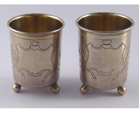 A pair of Russian silver vodka tots on ball feet , I K (Cyrillics) Moscow, 1894. wt.75gm. 