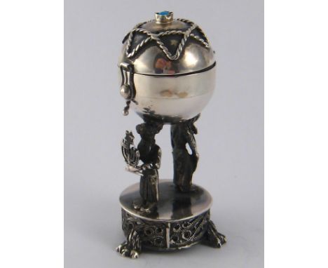 Judaica. A silver spice container, the container globe supported by two Rabbinical figures. Ht.8.5cm. Pseudo assay marks for 