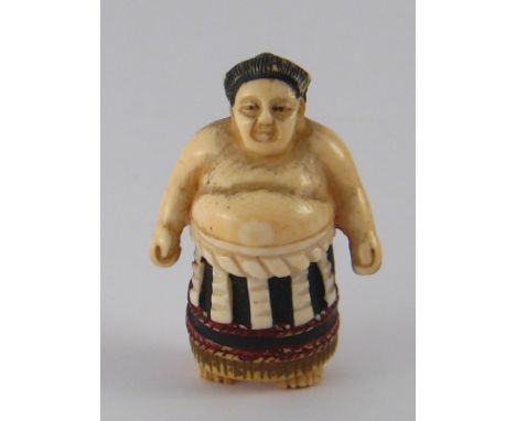 A Japanese ivory netsuke of a sumo wrestler, signed beneath foot. ht.5cm. Circa 1910.