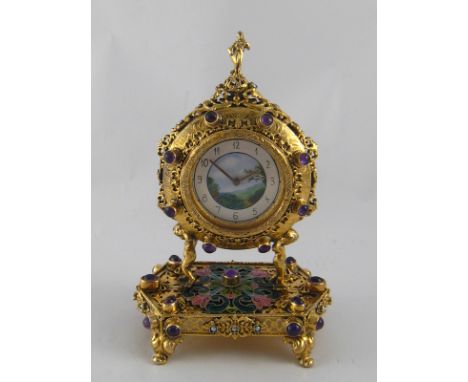 A fine gilt metal mantel clock, the hexagonal base on four scroll feet with fretted panels and shaded cloisonne enamel centre