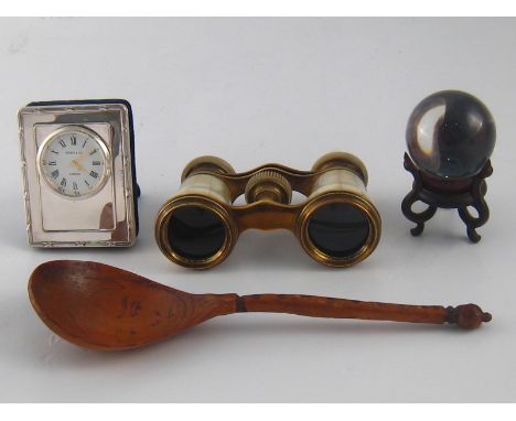 A mixed lot, being a pair of m.o.p. opera glasses, a glass ball on stand, a carved wooden spoon and a silver faced quartz clo