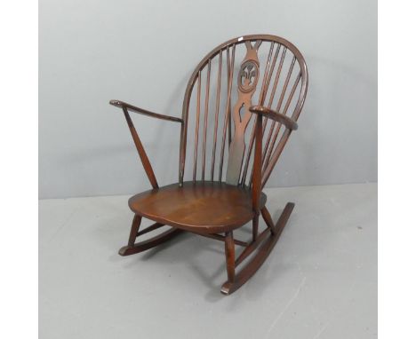 ERCOL - A mid-century model 316 rocking chair, with fleur-de-lis decoration and blue maker's label. 