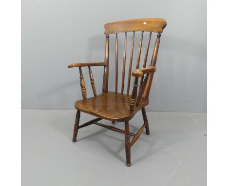 An elm-seated Windsor kitchen stick-back open armchair. 