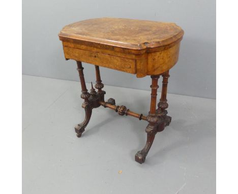 A Victorian burr walnut fold-over games table, with single frieze drawer, on quadruple base with carved and satinwood inlaid 