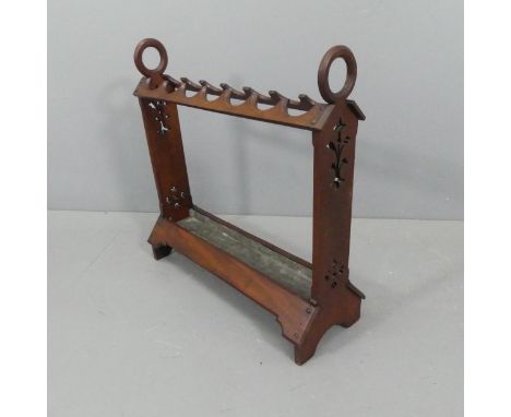 An early 20th century Arts & Crafts style mahogany stick / umbrella stand, with cut-out floral decoration and original drip t