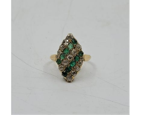 A precious yellow metal, emerald and diamond dress ring, the gallaried navette mount having fifteen graduated old-cut diamond