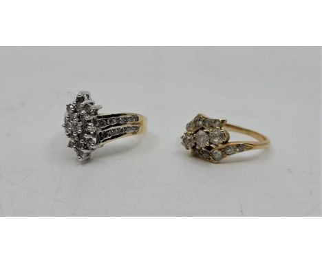 A precious metal diamond cluster ring,&nbsp;channel set double row of round brilliant cut diamond to each shoulder, (yellow m