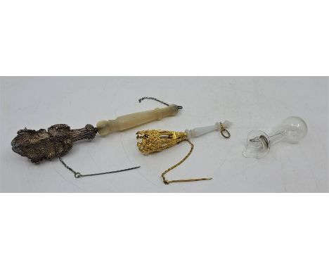 A 19th century white metal and mother of pearl posy holder, having white metal filigree top fitted pin, to turned mother of p