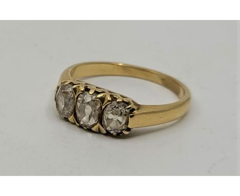 A Victorian precious yellow metal three stone diamond ring, set three graduated oval cut diamonds (estimated total diamond we