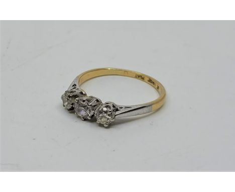 An 18ct. gold and platinum three stone diamond ring, set three graduated old-cut diamonds, stamped "18ct. Plat.", (gross weig