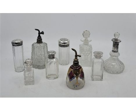 A collection of nine glass toiletry jars atomisers and scent bottles, some silver mounted (condition varies, one bottle as fo