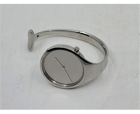 A Vivianna Torun for Georg Jensen stainless steel quartz bangle watch, design No.326, c.1987, having mirrored dial and offset