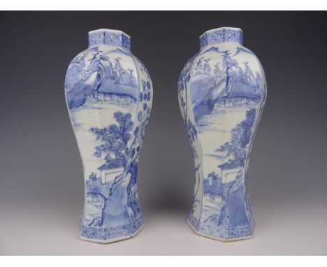 A pair of Chinese porcelain blue and white vases with landscape-kangxi 1662-1722. Height 25,5 cm. One vase is in good conditi