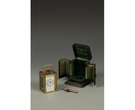A FRENCH BRASS CASED MINATURE CARRIAGE CLOCK, the white enamelled dial with Roman numerals, in a plain brass case with swing 