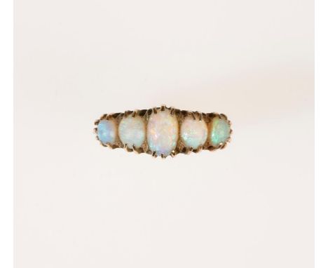 A FIVE STONE OPAL RING, the five graduated oval opal cabochons showing good blue-green iridescence, in a multiple claw settin