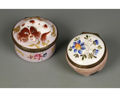 AN ENAMEL PATCH BOX, the lid modelled in the shape of a King Charles spaniel, laying on a pink ground with gilt scrolls and f