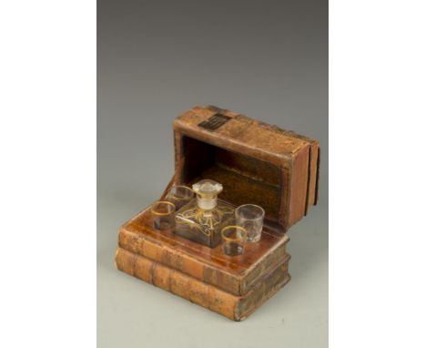 A 19TH CENTURY FRENCH DECANTER AND FOUR GLASSES, the decanter with painted gilt decoration contained within a case formed fro