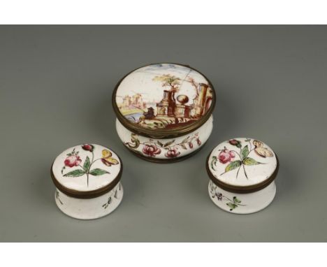 AN ENAMEL SNUFF BOX with painted floral decoration, on white ground, the hinged cover decorated with a landscape of ruins wit