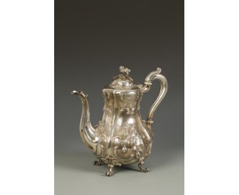 A VICTORIAN COFFEE POT of baluster form, the hinged cover with flower finial and leaf-capped scroll handle, embossed with flo