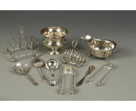 A COLLECTION OF SILVER ITEMS comprising a sauceboat by Viners, a sugar bowl, a toastrack, two pairs of sugar tongs, a small q